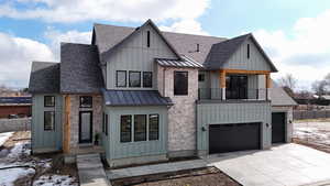 View of front of house featuring a balcony, a standing seam roof, board and batten siding, and roof with shingles