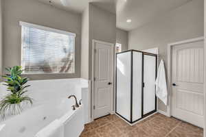 Full bath with a tub with jets, a shower stall, and tile patterned floors