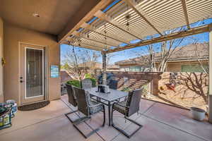 View of patio with fence, outdoor dining area, and a pergola