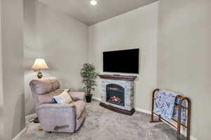 Sitting room featuring carpet and baseboards