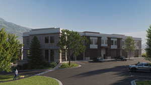 View of building exterior with uncovered parking and a mountain view