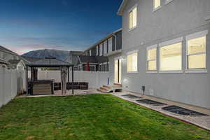 View of yard with a gazebo, a patio, a fenced backyard, and a hot tub