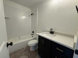 Bathroom featuring vanity, tub / shower combination, and toilet