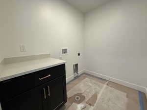 Laundry room with baseboards, hookup for a washing machine, cabinet space, and hookup for an electric dryer