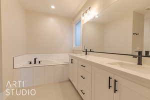 Full bathroom featuring a garden tub, double vanity, tile patterned flooring, and a sink