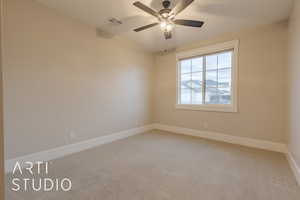 Empty room with baseboards, visible vents, and carpet flooring