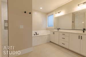 Full bathroom with a bath, double vanity, a sink, and recessed lighting