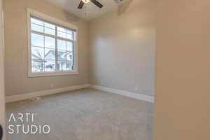 Unfurnished room with a ceiling fan, light colored carpet, visible vents, and baseboards