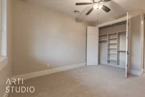 Unfurnished bedroom with a closet, visible vents, a ceiling fan, light carpet, and baseboards