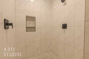 Full bath featuring tiled shower