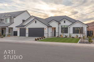 Modern inspired farmhouse with driveway, an attached garage, a lawn, and board and batten siding