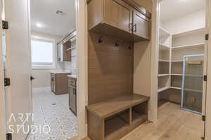 Mudroom featuring light wood-type flooring, visible vents, and baseboards