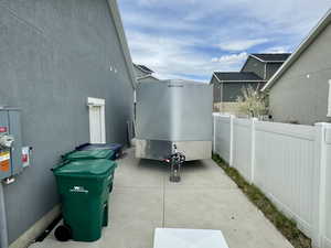 View of property exterior with fence and stucco siding