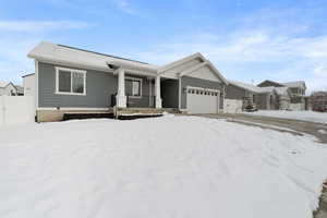 View of front of property featuring a garage and covered porch