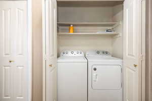 Clothes washing area featuring laundry area and separate washer and dryer