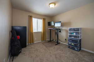 Bedroom with light carpet and baseboards