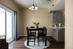 Dining room featuring a healthy amount of sunlight, baseboards, and dark wood-style flooring