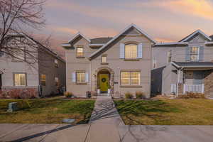 Traditional-style home with stucco siding and a front yard