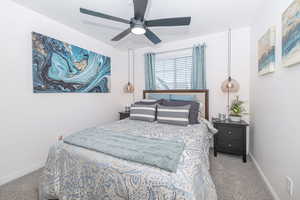 Bedroom with carpet, ceiling fan, and baseboards