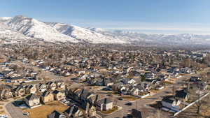 Snowy aerial view with a residential view and a mountain view