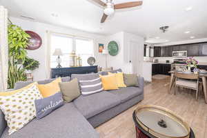 Living area featuring recessed lighting, visible vents, ceiling fan, and light wood finished floors