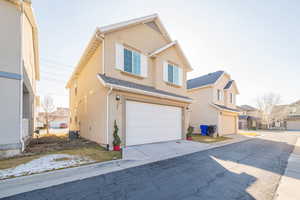 View of back of home with garage and sideyard