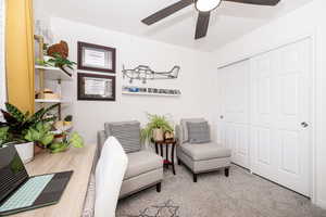 Sitting room with ceiling fan and carpet flooring