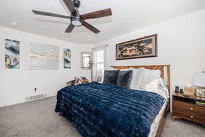 Primary Bedroom featuring carpet floors, baseboards, visible vents, and a ceiling fan