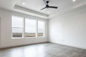 Spare room featuring recessed lighting, visible vents, ceiling fan, light wood-type flooring, and baseboards