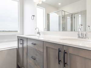 Full bath featuring double vanity, wood finished floors, a sink, and visible vents