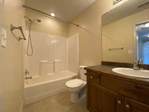 Full bathroom with visible vents, toilet, vanity, tile patterned floors, and shower / bathtub combination