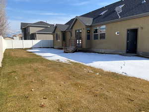 Back of house with a lawn, a fenced backyard, roof with shingles, a patio area, and stucco siding