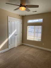 Unfurnished bedroom featuring baseboards, visible vents, and carpet flooring