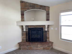 Interior details featuring carpet flooring, a fireplace, and baseboards