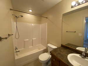 Full bath featuring tile patterned flooring, tub / shower combination, vanity, and toilet