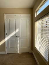 Interior space with carpet floors and baseboards