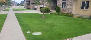 View of yard featuring driveway and a garage