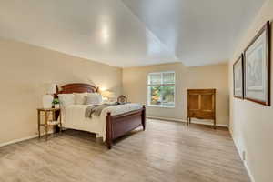 Bedroom featuring light wood-type flooring and baseboards