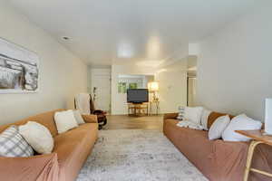 Living area featuring light wood-style floors and visible vents