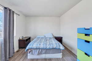 Bedroom featuring light wood-type flooring and baseboards