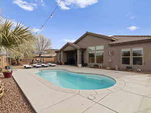 View of pool with a patio area, a fenced in pool, and fence