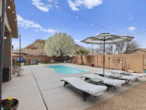 View of pool with a fenced in pool, a patio area, a mountain view, and a fenced backyard