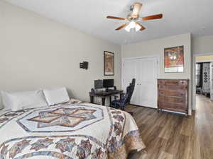 Bedroom with a closet, a ceiling fan, and wood finished floors