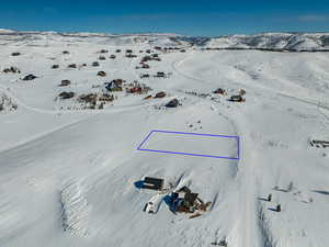 Snowy aerial view featuring a mountain view