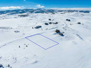 Snowy aerial view featuring a mountain view and soldier Creek Bay across the street