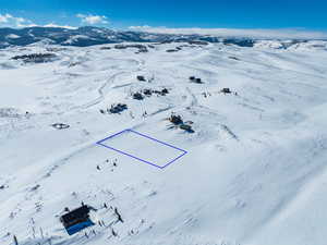 Snowy aerial view with a mountain view