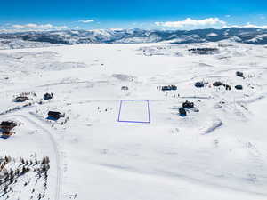 Snowy aerial view with a mountain view,