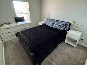 Bedroom with carpet floors and a textured ceiling