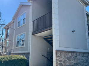 View of property exterior featuring a balcony and stucco siding