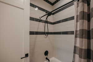 Full bathroom featuring shower / bath combo with shower curtain